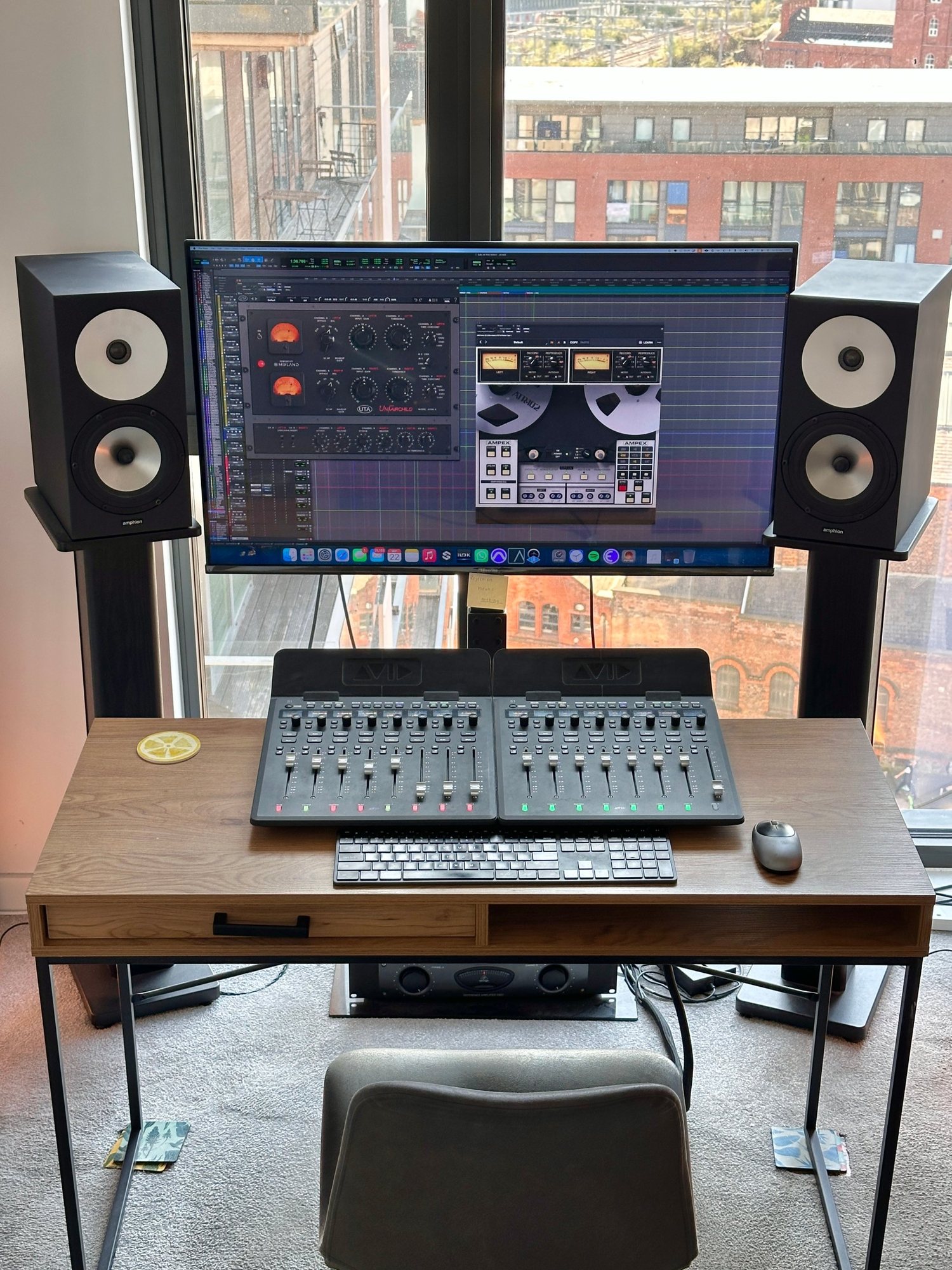 Joshua's mixing desk with Avid control surfaces, Amphion monitors and a window over Manchester