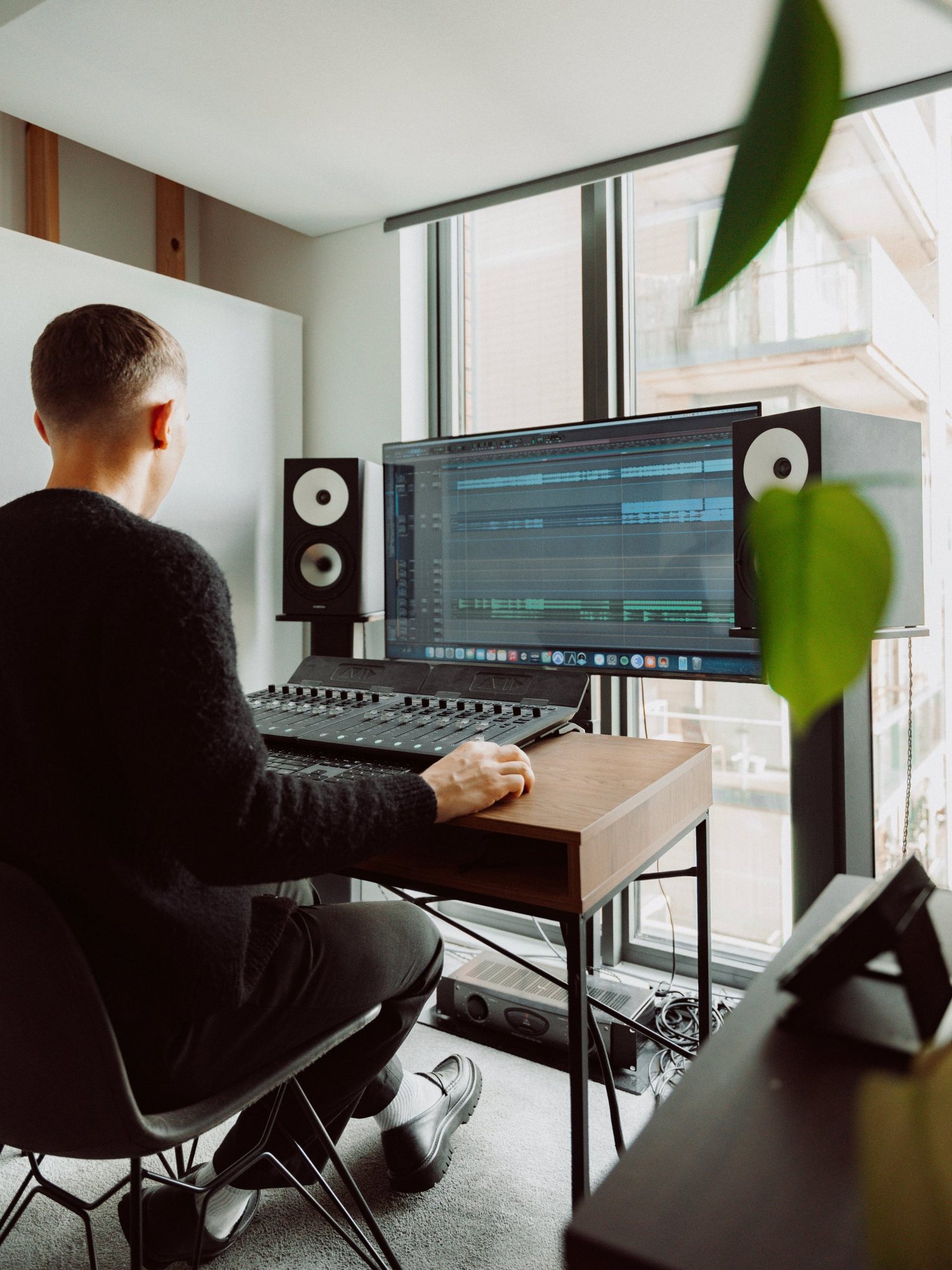 Joshua working on a mix beside the Amphion monitors