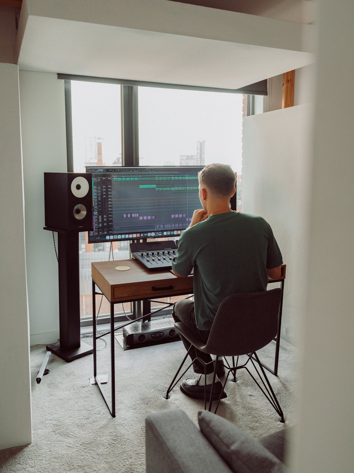 Joshua mixing at his desk in the studio